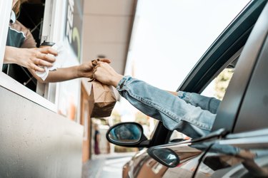 person at a drive-thru getting healthy fast food options