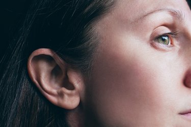 a close up side profile photo of a young adult's ear, illustrating smelly ear wax