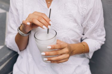 woman holding glass of psyllium husk mixed with water