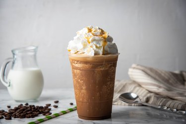 Caramel Frappuccino With Whipped Cream on Marble Table, One of the Worst Foods for Your Heart